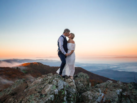 couple married during sunrise on mountain