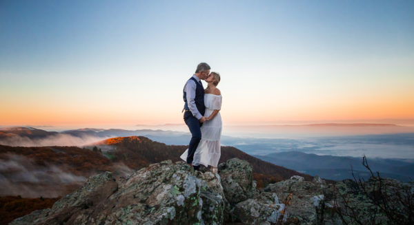 couple married during sunrise on mountain