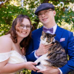 couple holding a pet cat