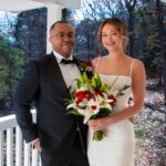 man and woman standing on porch of a cottage