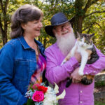 man and woman holding a cat