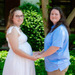 photo of two women holding hands