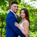 a photo of a man in a suit hugging a woman who is wearing a white dress