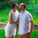 a woman kisses a man outside a building